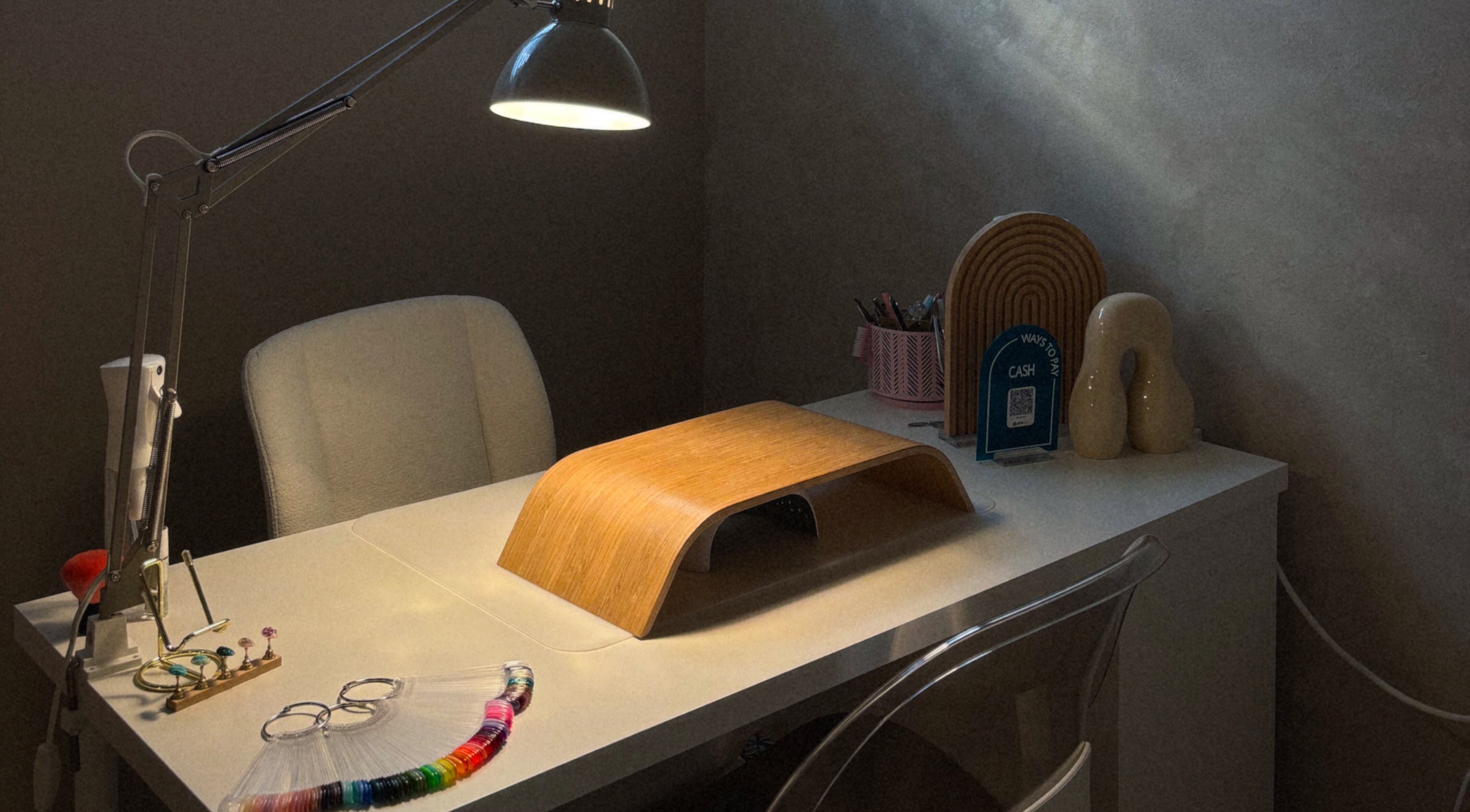 Cozy nail station at Blizzthetic, San Juan, PR featuring a lamp and manicure tools.