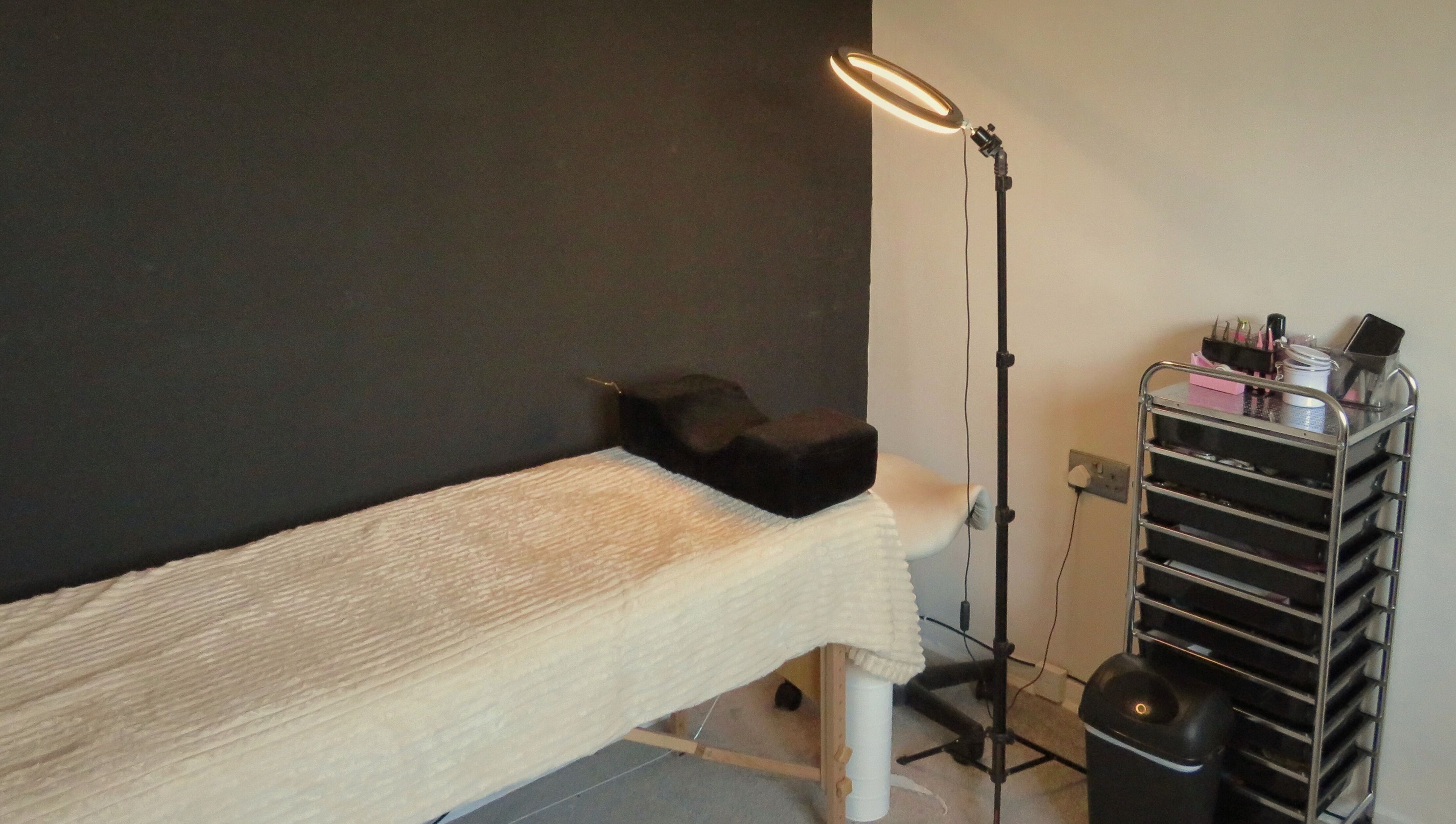 Treatment room at Twin Flame Beauty Room, East Kilbride, Scotland, GB with bed and beauty tools.