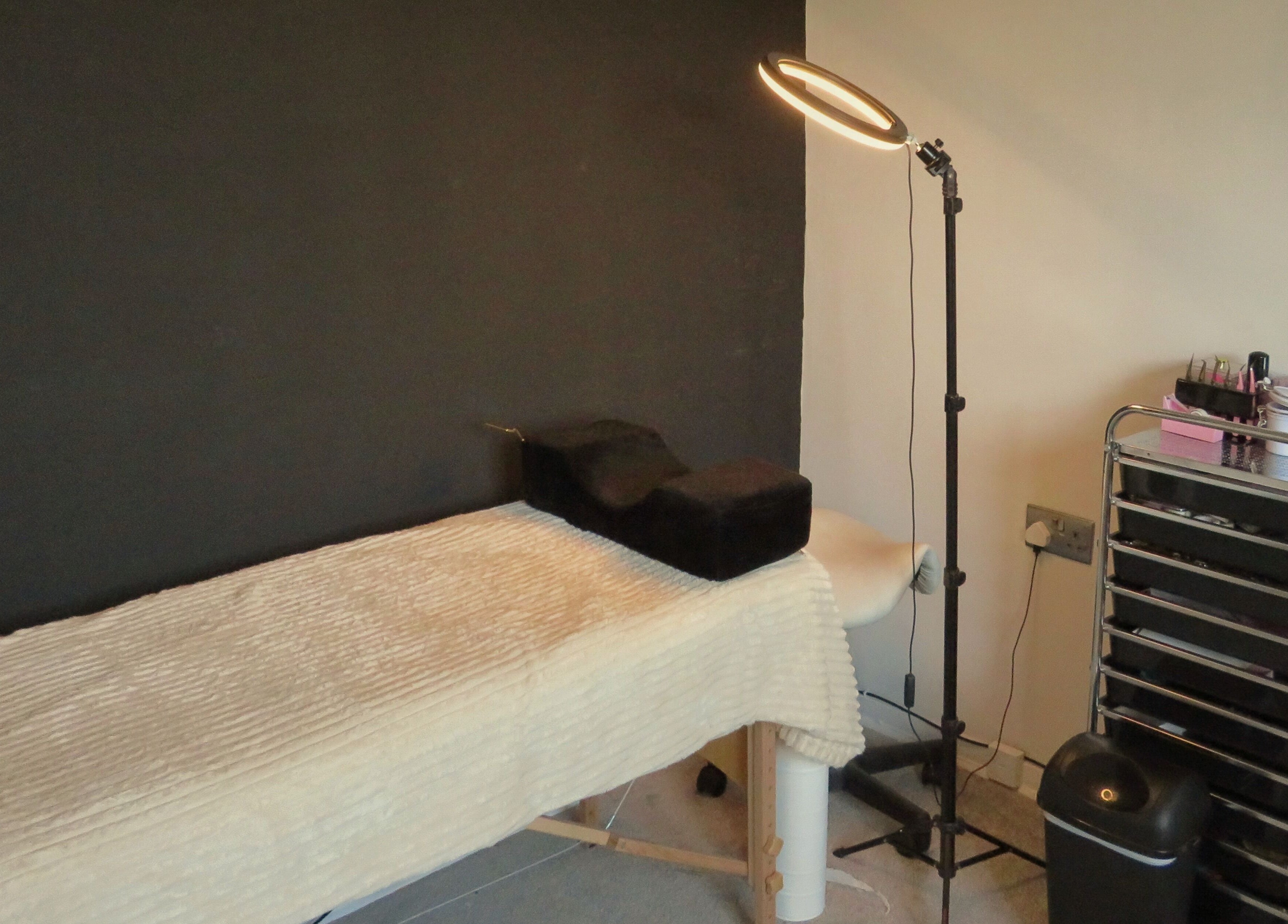 Treatment room at Twin Flame Beauty Room, East Kilbride, Scotland, GB with bed and beauty tools.