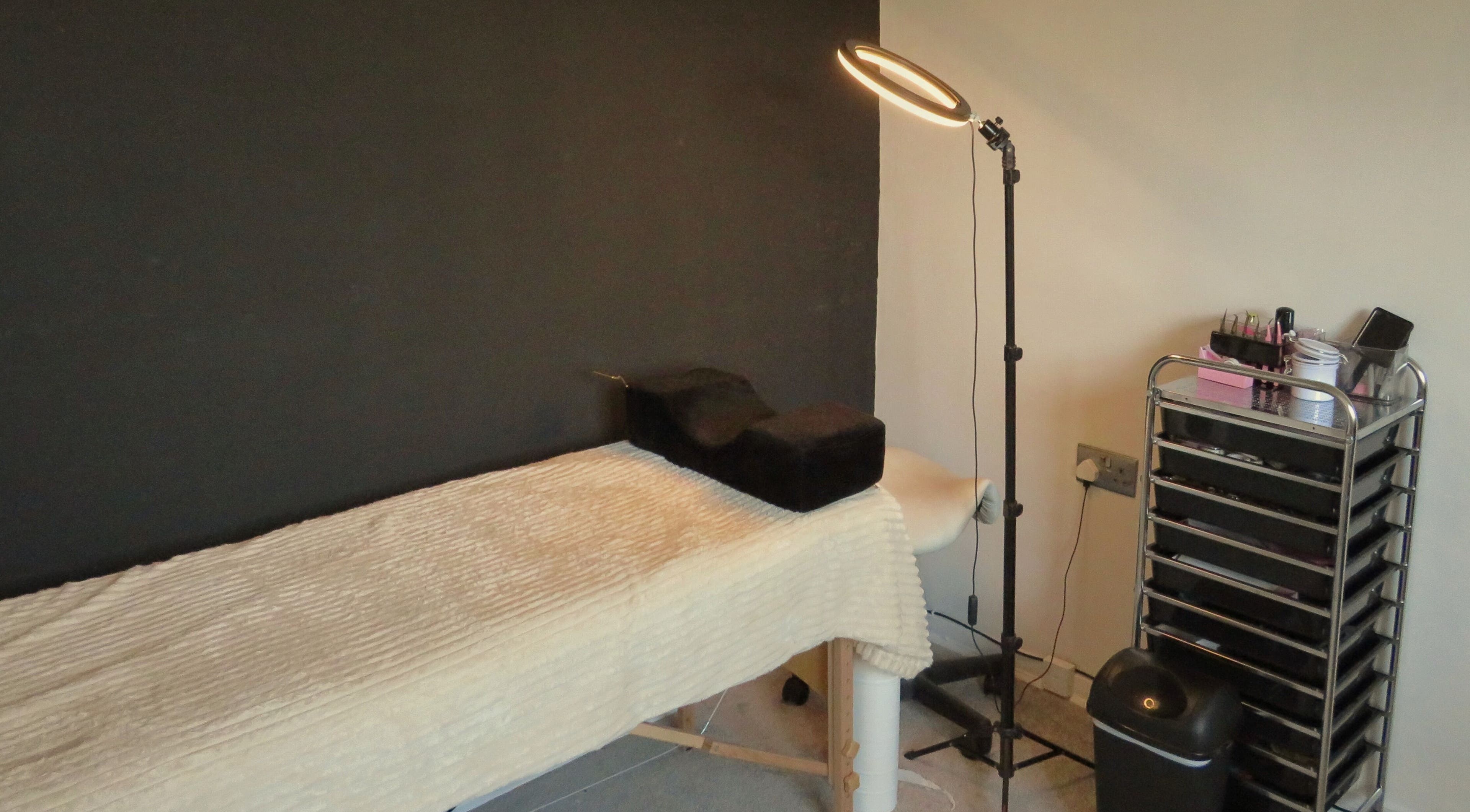 Treatment room at Twin Flame Beauty Room, East Kilbride, Scotland, GB with bed and beauty tools.