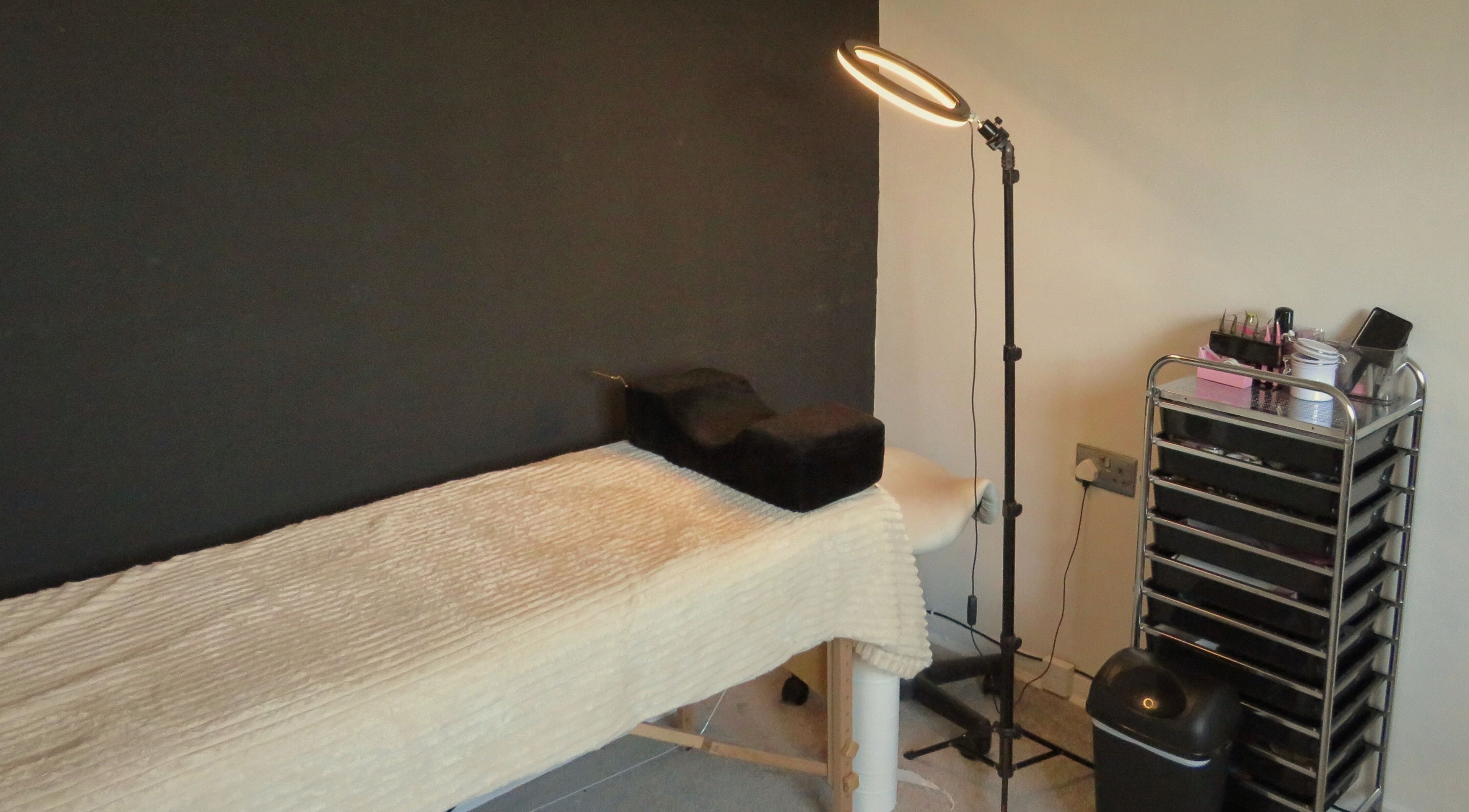 Treatment room at Twin Flame Beauty Room, East Kilbride, Scotland, GB with bed and beauty tools.