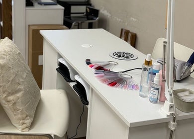 Elegant manicure table setup at Nails by Elena, Utrecht, Utrecht, NL with nail polish samples and tools.