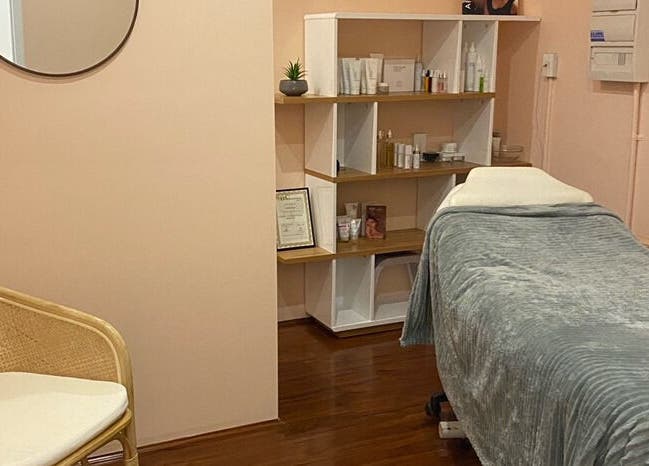 Relaxing treatment room at Classique Beauty and Skin, Ellenbrook, Western Australia, AU, with a plush bed and serene decor.