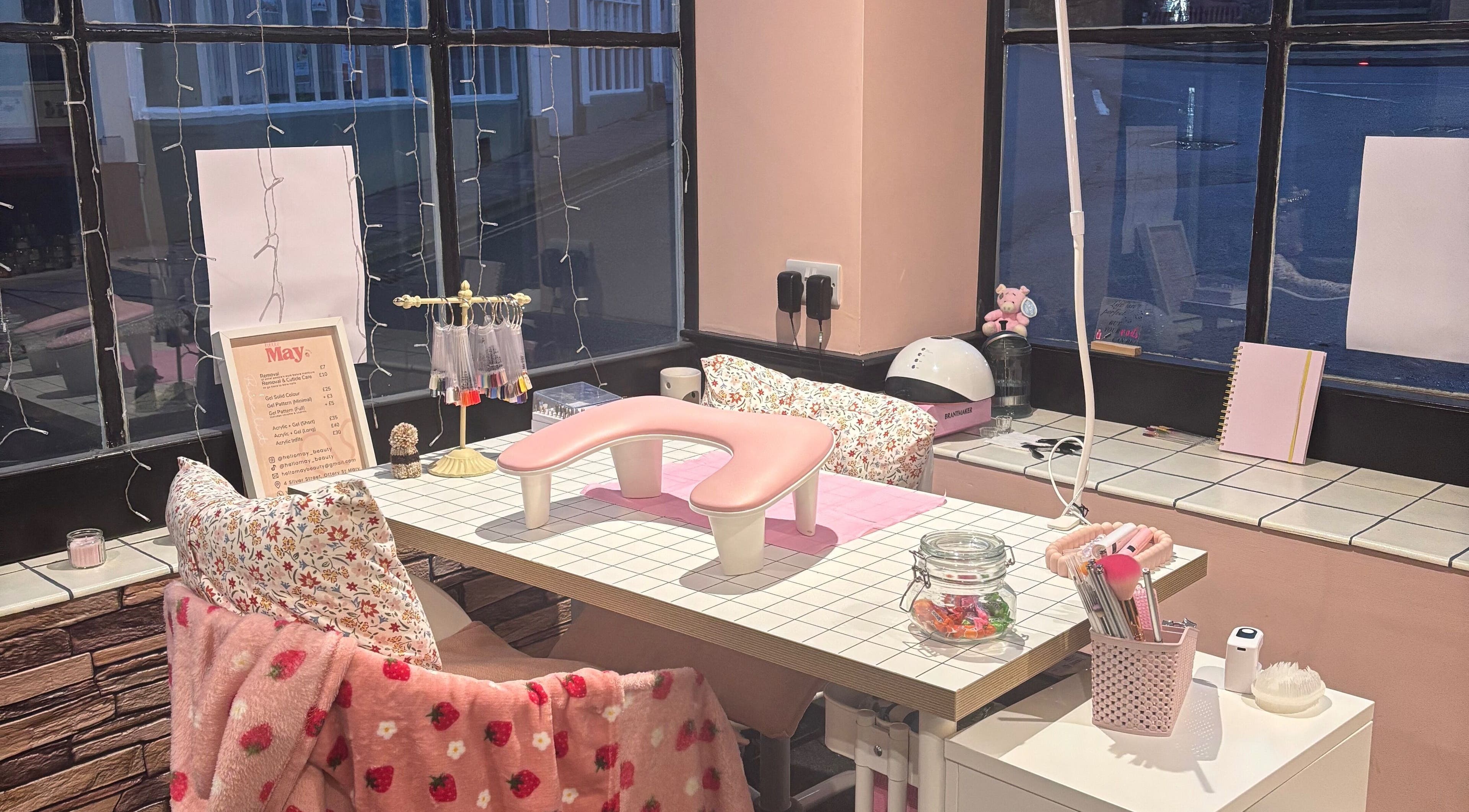 Cozy nail station at Hello May Beauty, Ottery Saint Mary, England, GB, with elegant pink decor.