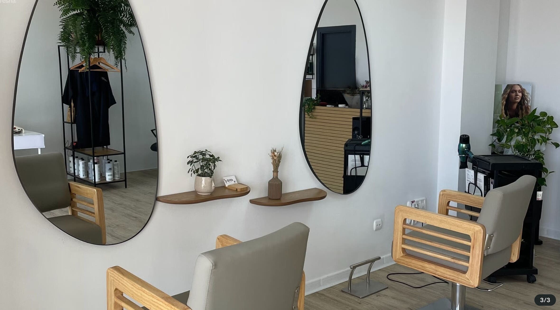 Modern salon interior at DIVA STUDIO, L'alfàs Del Pi, Comunidad Valenciana, ES with elegant mirrors and seating.