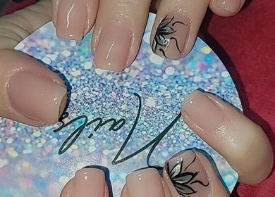 Nail art featuring nude polish and floral design at Chella's Beauty and Photography, Emalahleni, Mpumalanga, ZA.