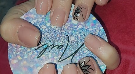 Nail art featuring nude polish and floral design at Chella's Beauty and Photography, Emalahleni, Mpumalanga, ZA.