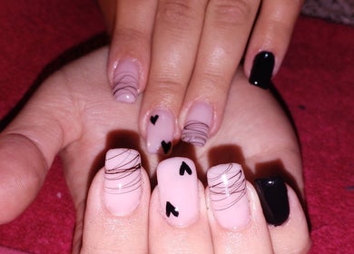 Nail art design at Chella's Beauty and Photography in Emalahleni, Mpumalanga, ZA featuring pink and black patterns.