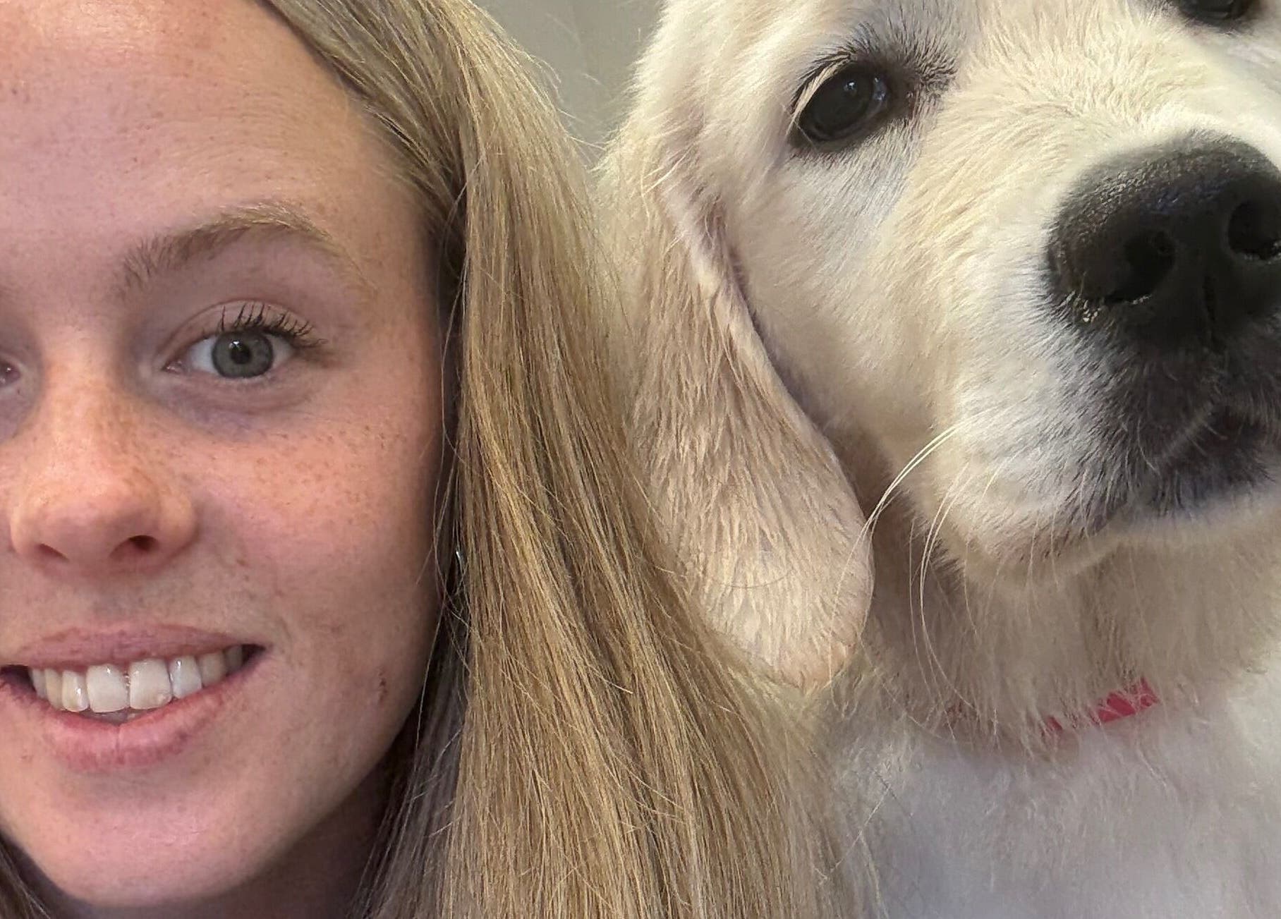 Smiling woman with dog at Susie Qs Dog Grooming, Copplestone, England, GB.