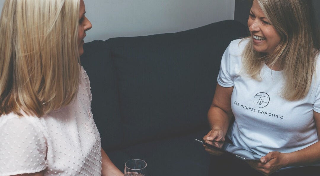 Consultation at The Surrey Skin Clinic, Oxted, England, GB with staff member engaging with a client.