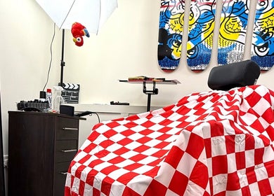 Colorful barber chair and decor at Sharps The Barber - SC Studio 105, Manchester, England, GB.