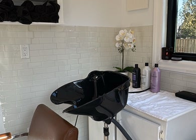 Chic hair washing station at Laur’s Glam Files in Brantford, Ontario, CA with modern decor and luxury products.