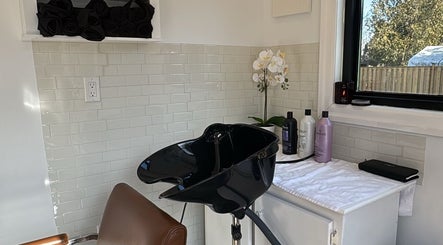 Chic hair washing station at Laur’s Glam Files in Brantford, Ontario, CA with modern decor and luxury products.