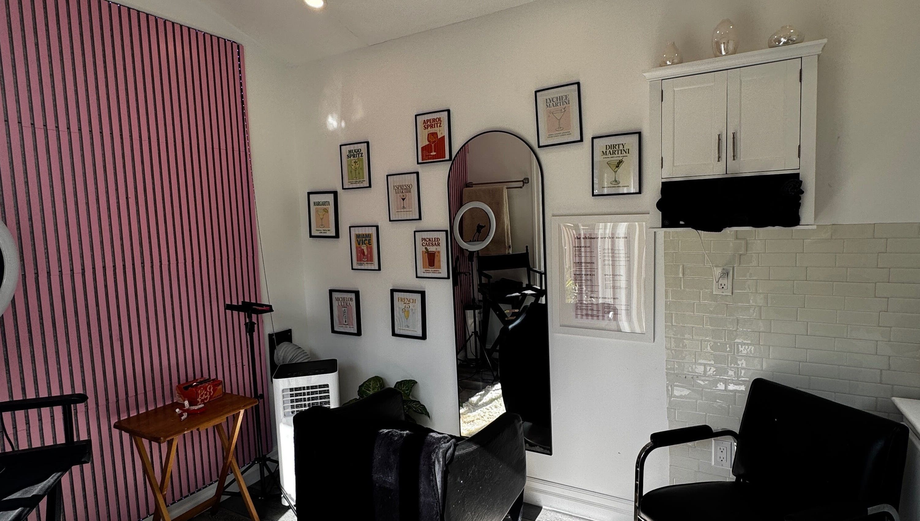 Stylish salon interior at Laur’s Glam Files, Brantford, Ontario, CA with chic pink walls and artistic decor.