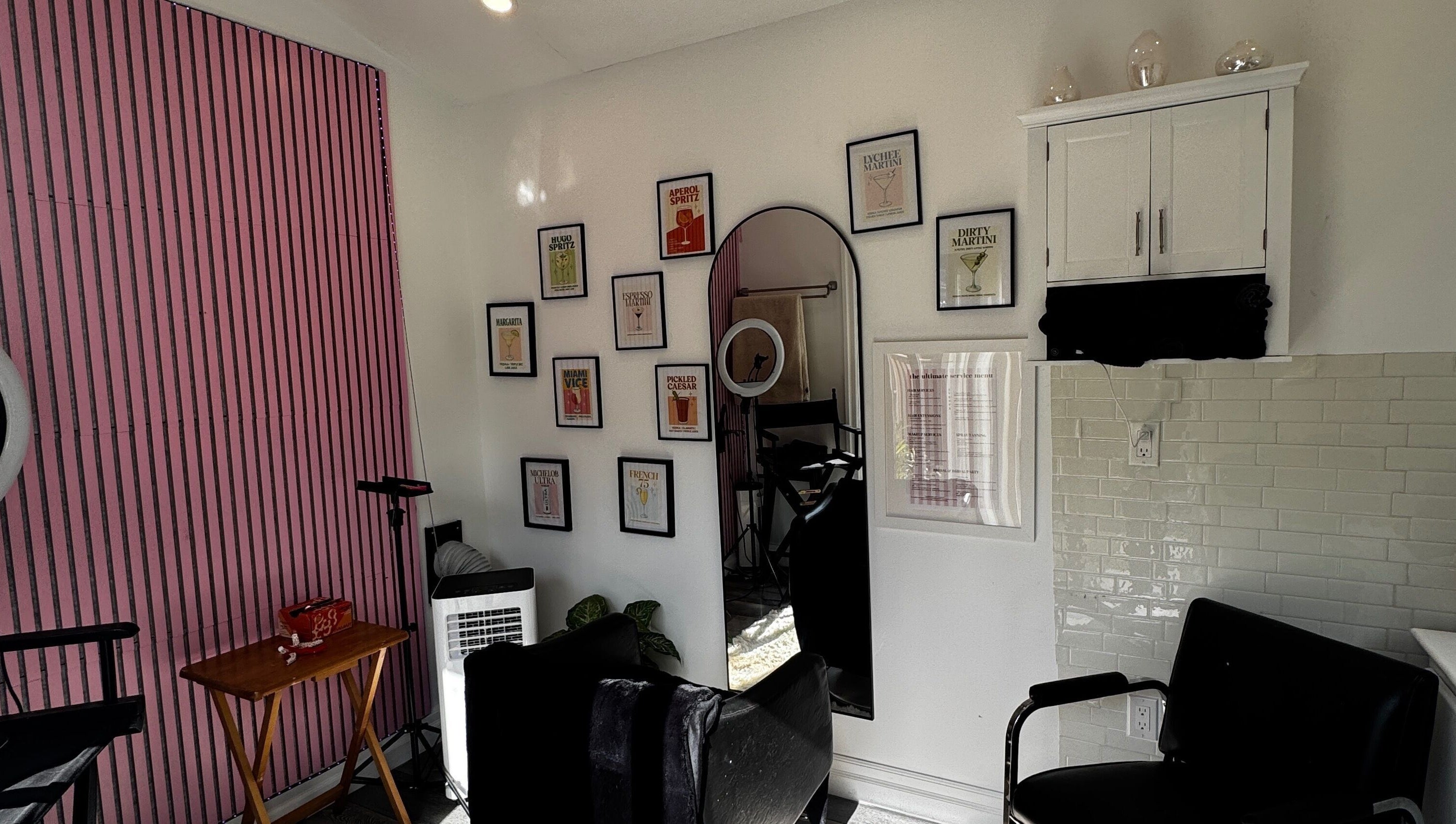 Stylish salon interior at Laur’s Glam Files, Brantford, Ontario, CA with chic pink walls and artistic decor.