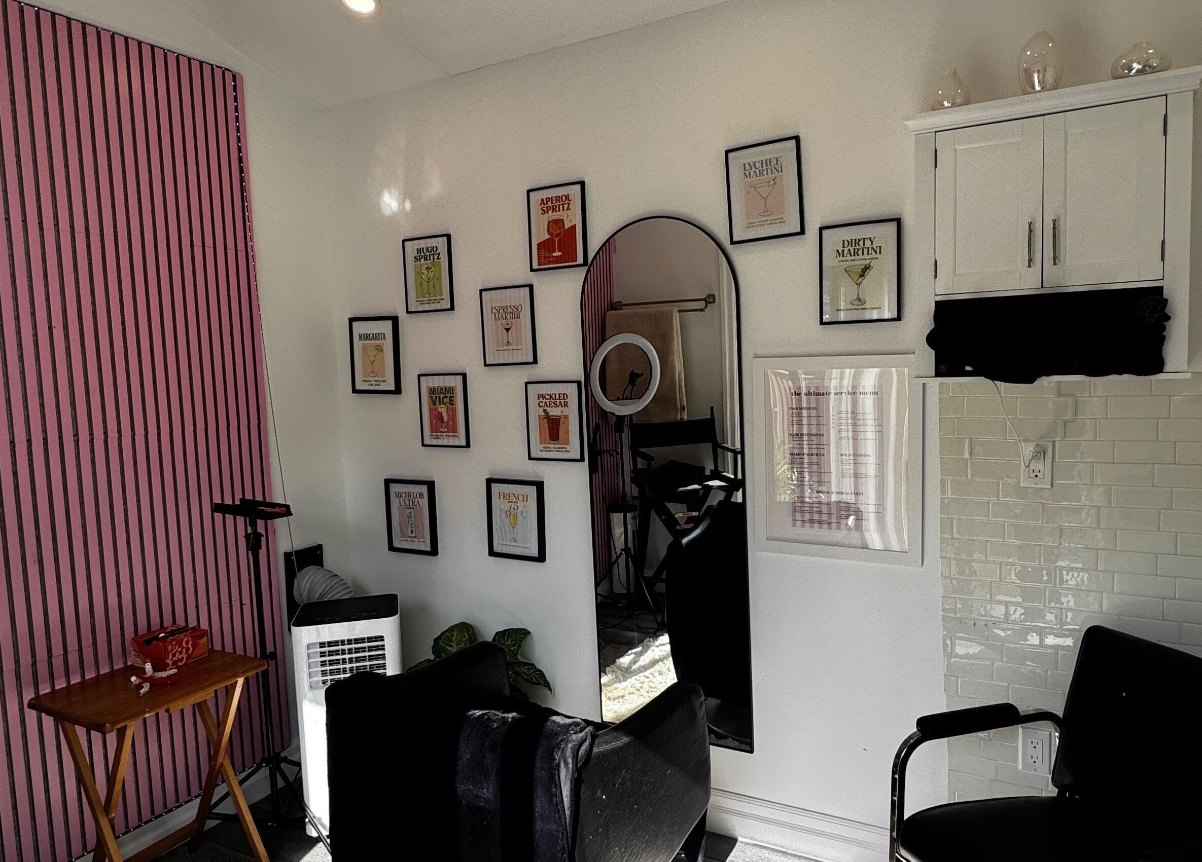 Stylish salon interior at Laur’s Glam Files, Brantford, Ontario, CA with chic pink walls and artistic decor.