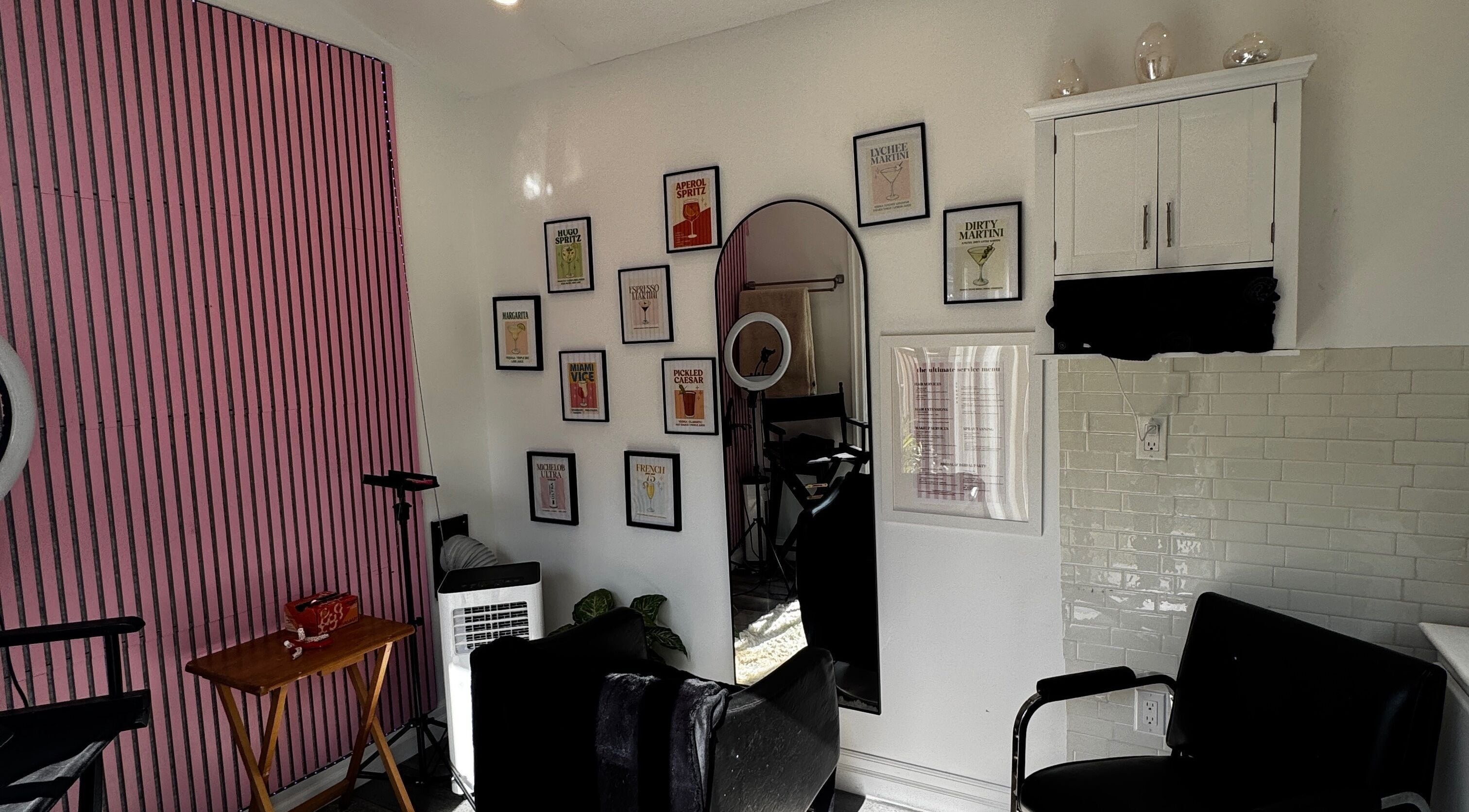 Stylish salon interior at Laur’s Glam Files, Brantford, Ontario, CA with chic pink walls and artistic decor.