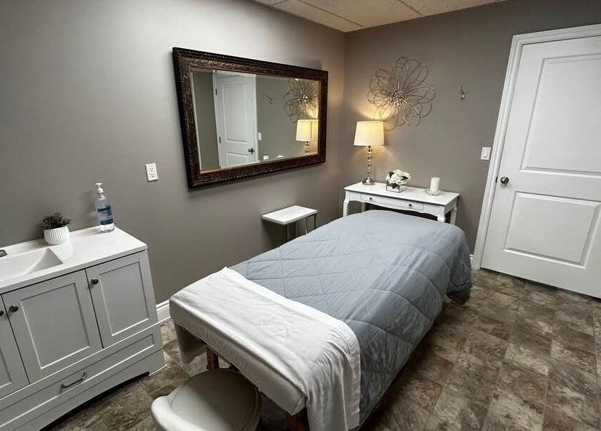 Peaceful spa room at Panache Spa & Academy, Midland, Ontario, CA with massage table and elegant decor.