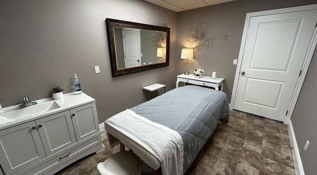 Peaceful spa room at Panache Spa & Academy, Midland, Ontario, CA with massage table and elegant decor.