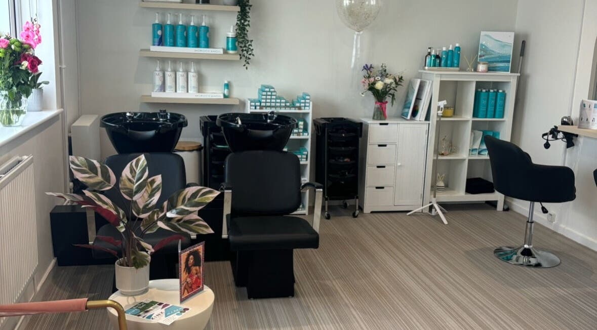 Stylish salon at Summer Rose Hairdressing, East Goscote, England, GB. Modern chairs, beauty products, and decor.