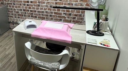 Nail station at Lizelle Beauty, Aesthetics & Nails, Bloemfontein, Free State, ZA, with pink towel and UV lamp.