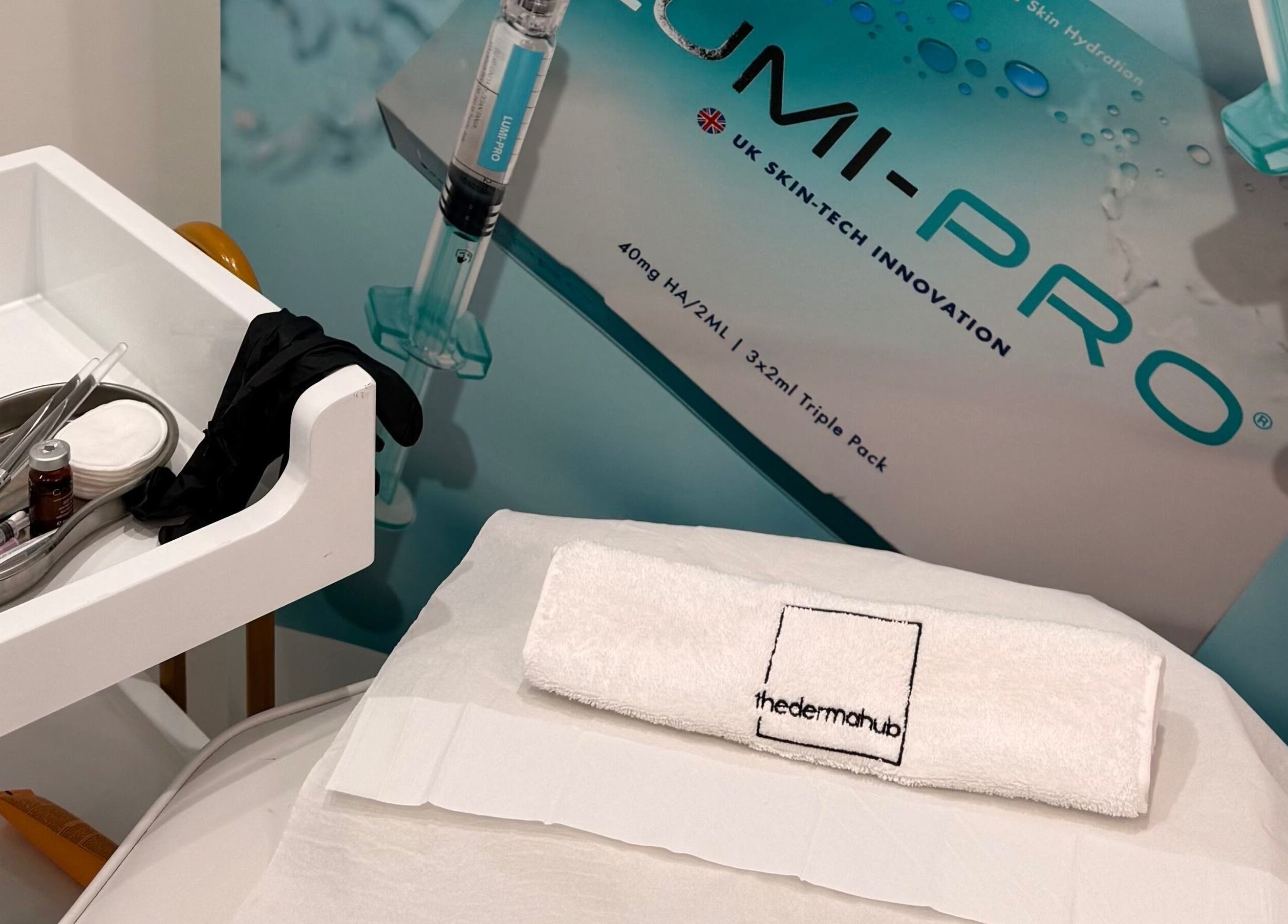 Treatment setup at Thedermahub, Wallasey, England, GB, featuring tools and a towel with branding.