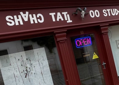 Außenansicht von Shach Tattoo Studio mit leuchtendem 'Open'-Schild in Merseburg, Sachsen-Anhalt, DE.
