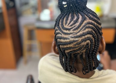 Intricate braided hairstyle at Salon D'or, expertly crafted in George Town, George Town, KY.