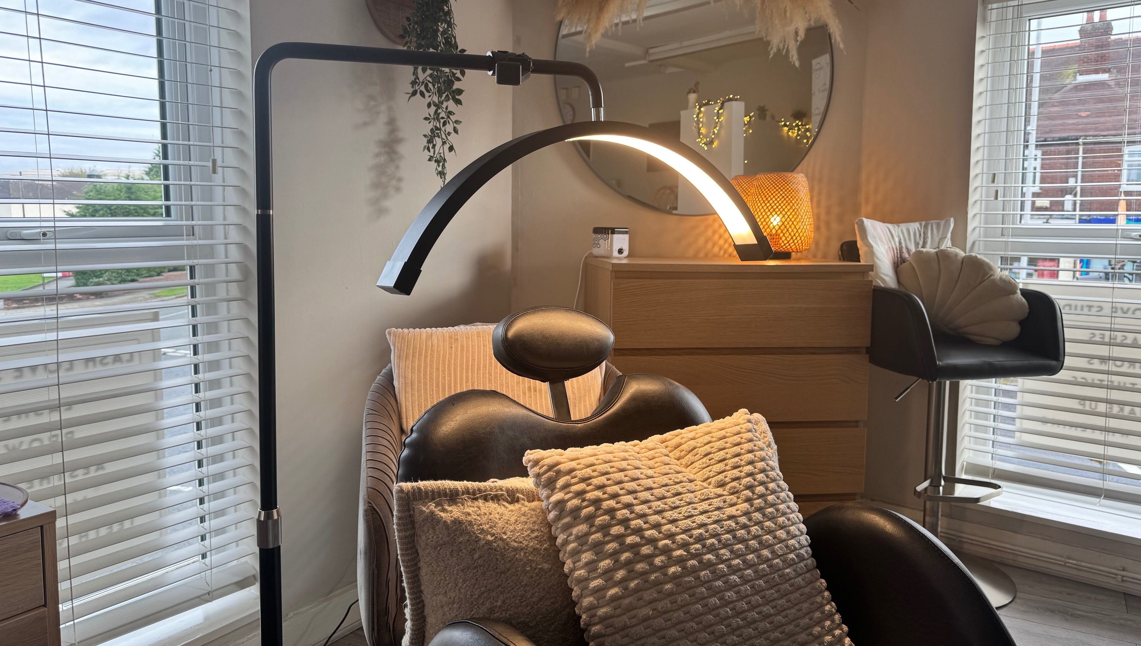 Relaxing beauty chair and decor at Lenka Beauty, Wirral, England, GB, with natural light and comfortable cushions.