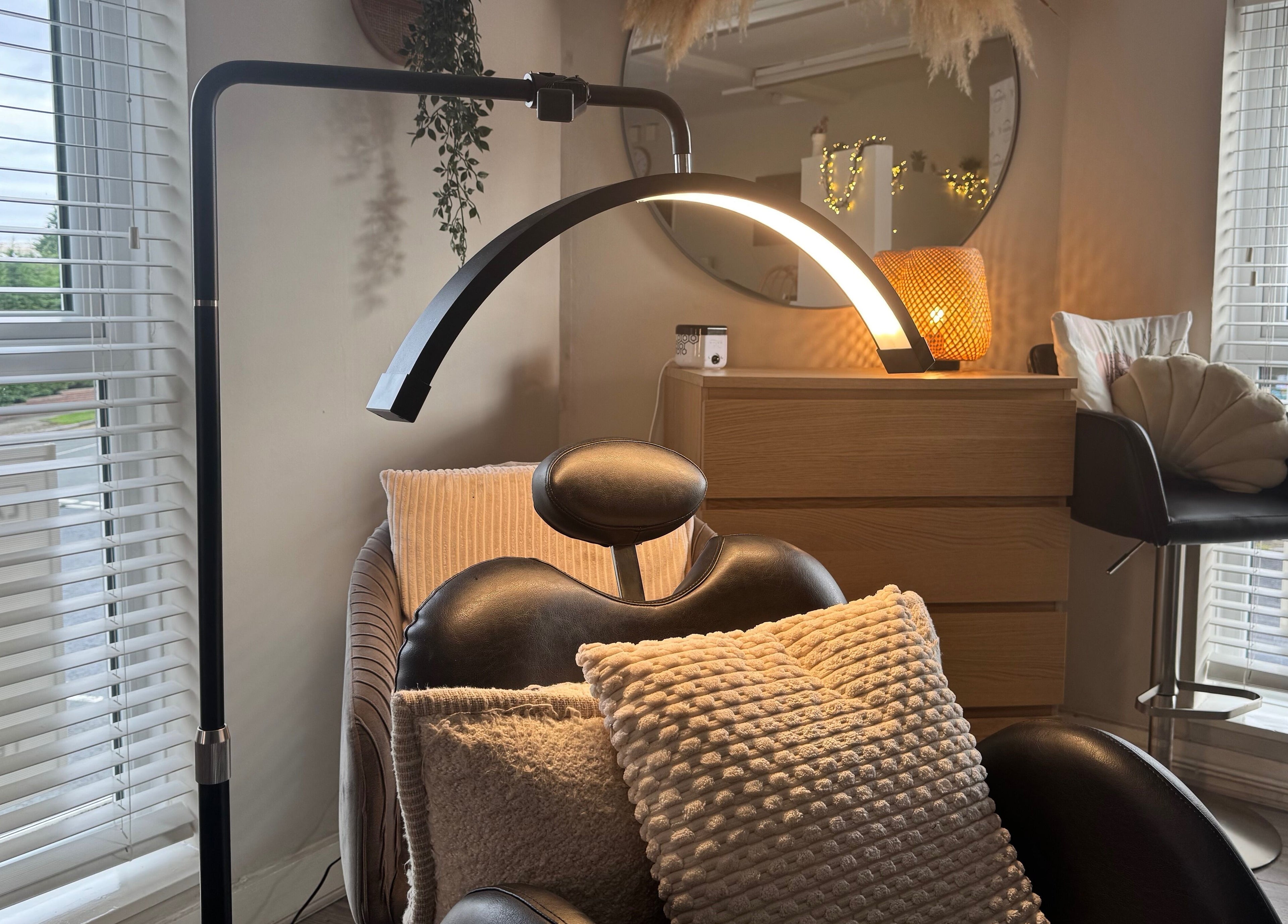Relaxing beauty chair and decor at Lenka Beauty, Wirral, England, GB, with natural light and comfortable cushions.