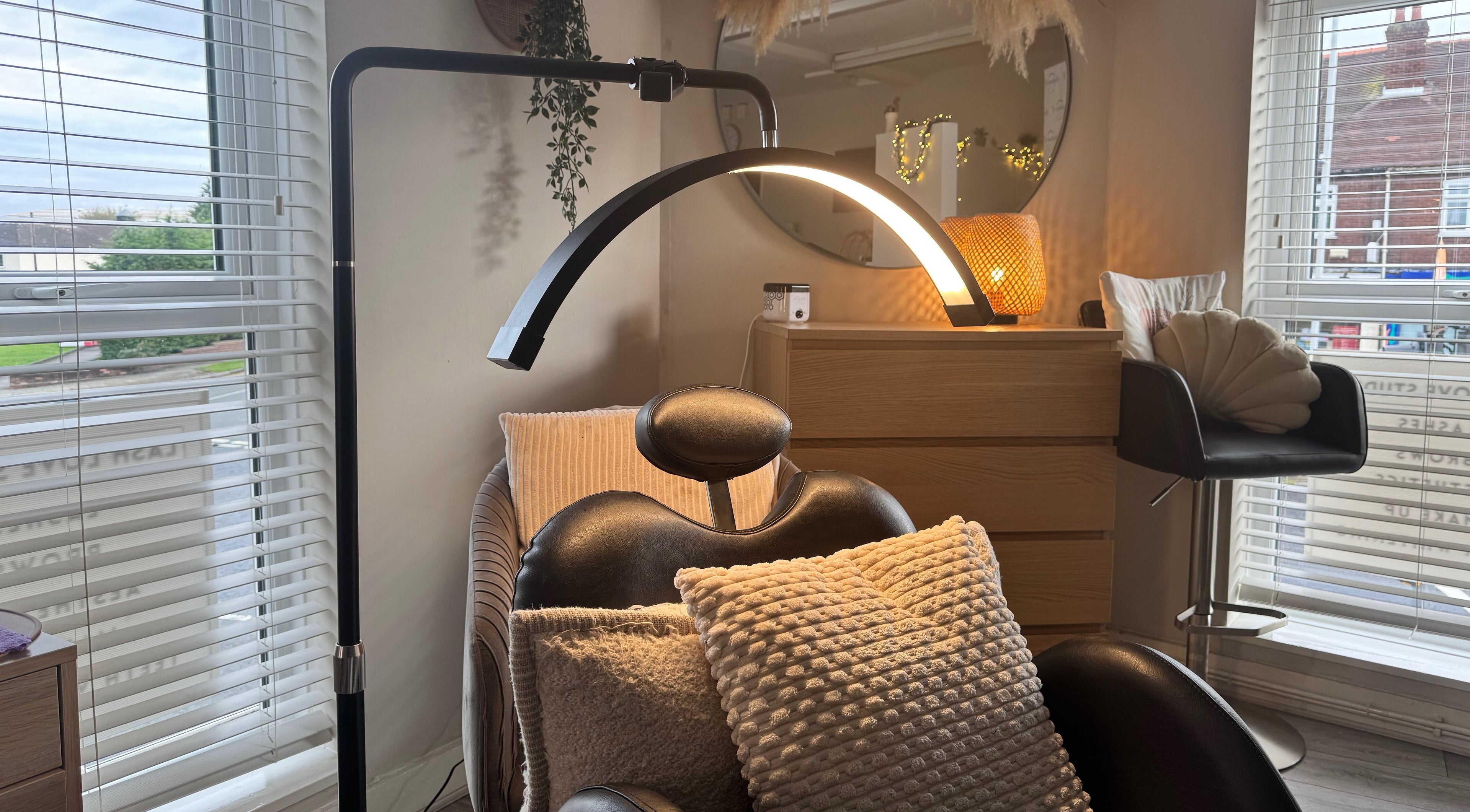Relaxing beauty chair and decor at Lenka Beauty, Wirral, England, GB, with natural light and comfortable cushions.