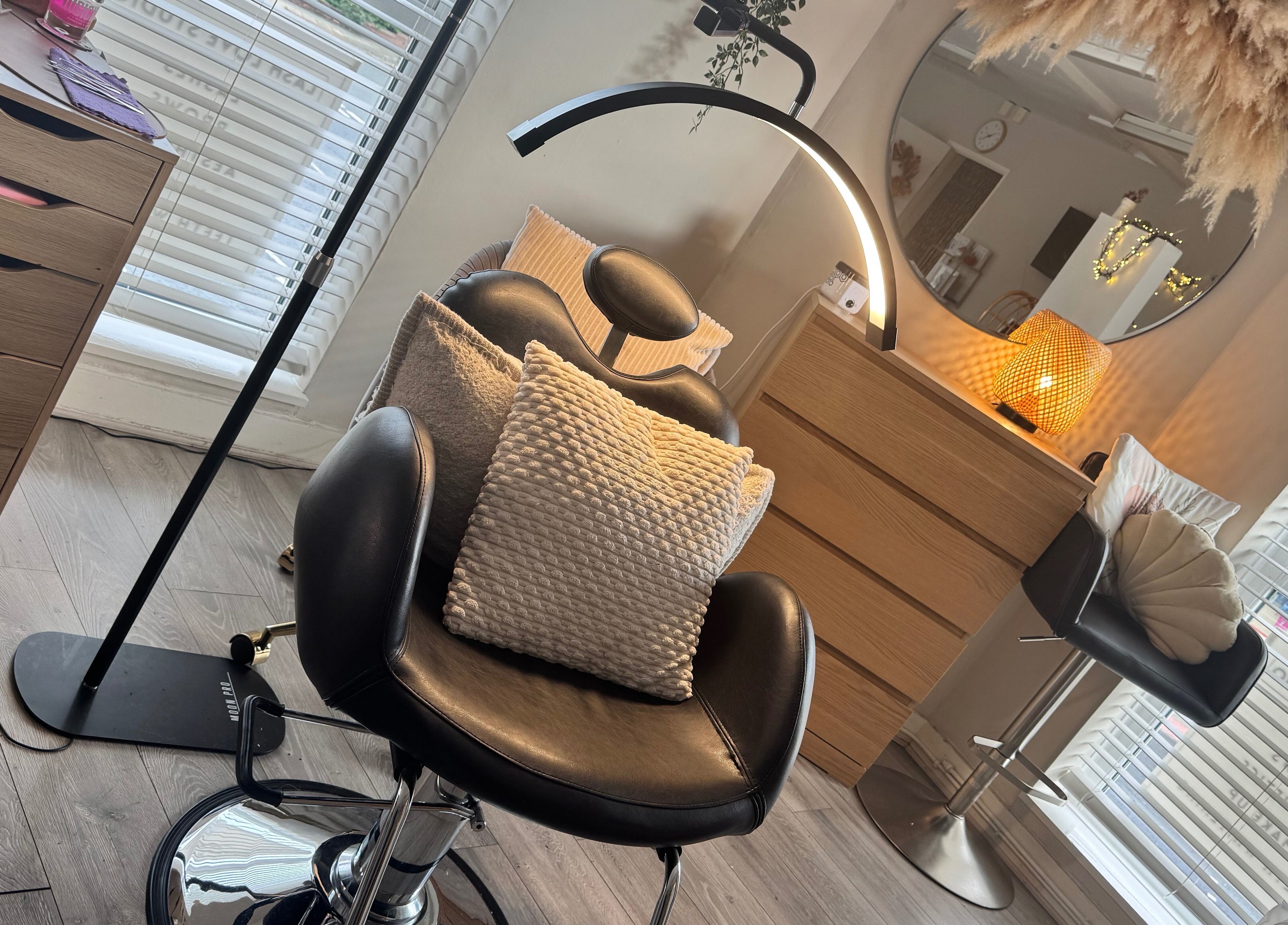 Relaxing beauty corner at Lenka Beauty, Wirral, England, GB with plush seating and ambient lighting.