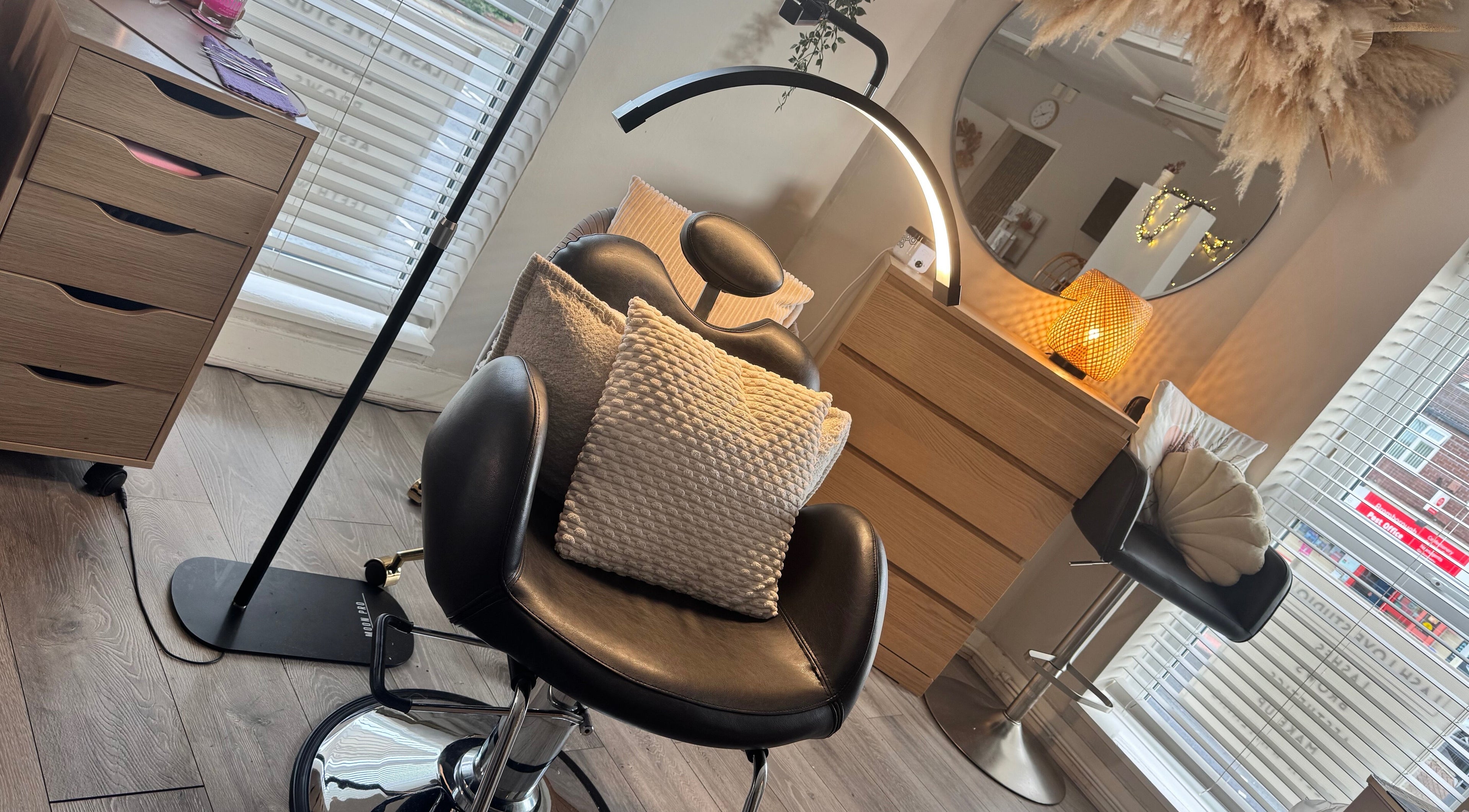 Relaxing beauty corner at Lenka Beauty, Wirral, England, GB with plush seating and ambient lighting.