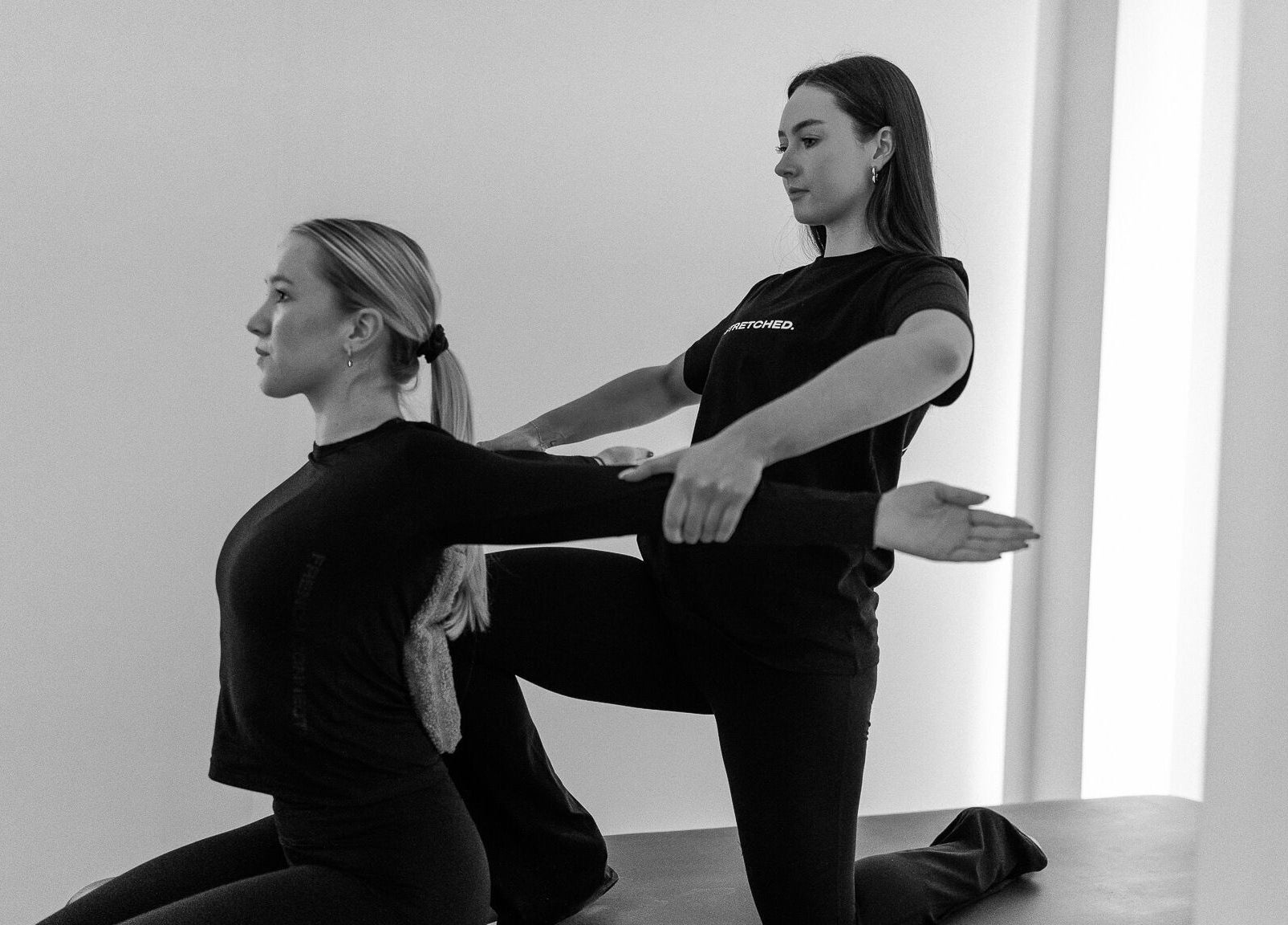 Instructor guides client in stretching at Stretched Edinburgh, Edinburgh, Scotland, GB wellness center.