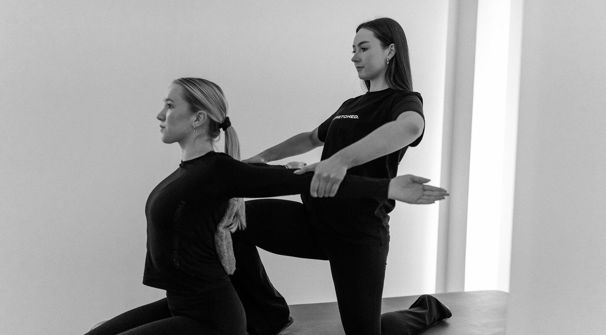 Instructor guides client in stretching at Stretched Edinburgh, Edinburgh, Scotland, GB wellness center.
