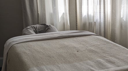 Cozy treatment room at KS Holistic Therapies, Bath, England, GB with soft natural light and a massage table.