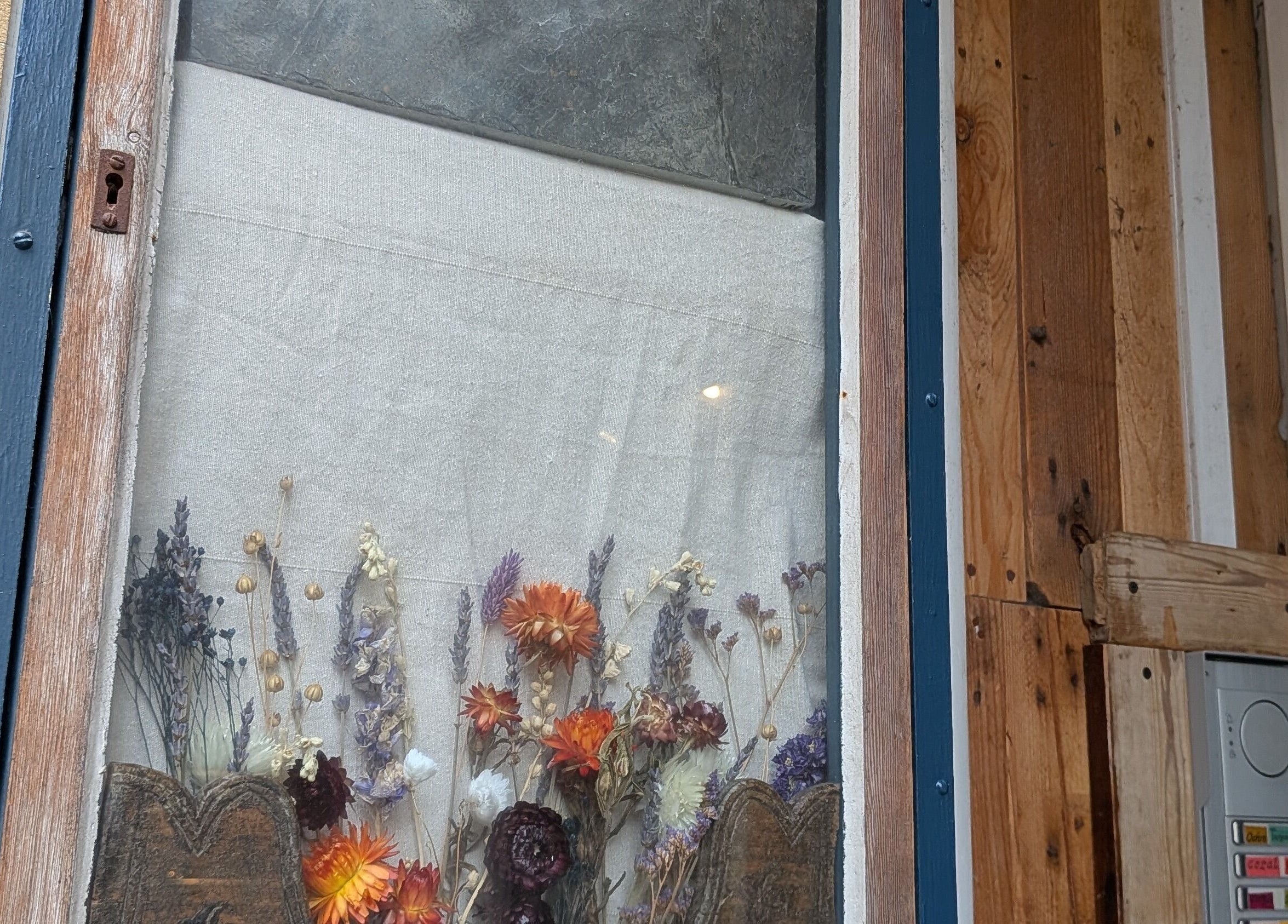 Dried flowers in the rustic wooden window of KS Holistic Therapies in Bath, England, GB.