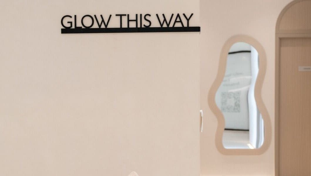 Entrance of Facette Facial Bar Jumeirah in Dubai, Dubai, AE, with 'Glow This Way' sign and modern decor.