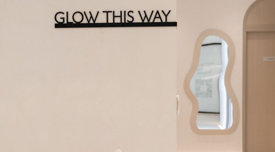 Entrance of Facette Facial Bar Jumeirah in Dubai, Dubai, AE, with 'Glow This Way' sign and modern decor.