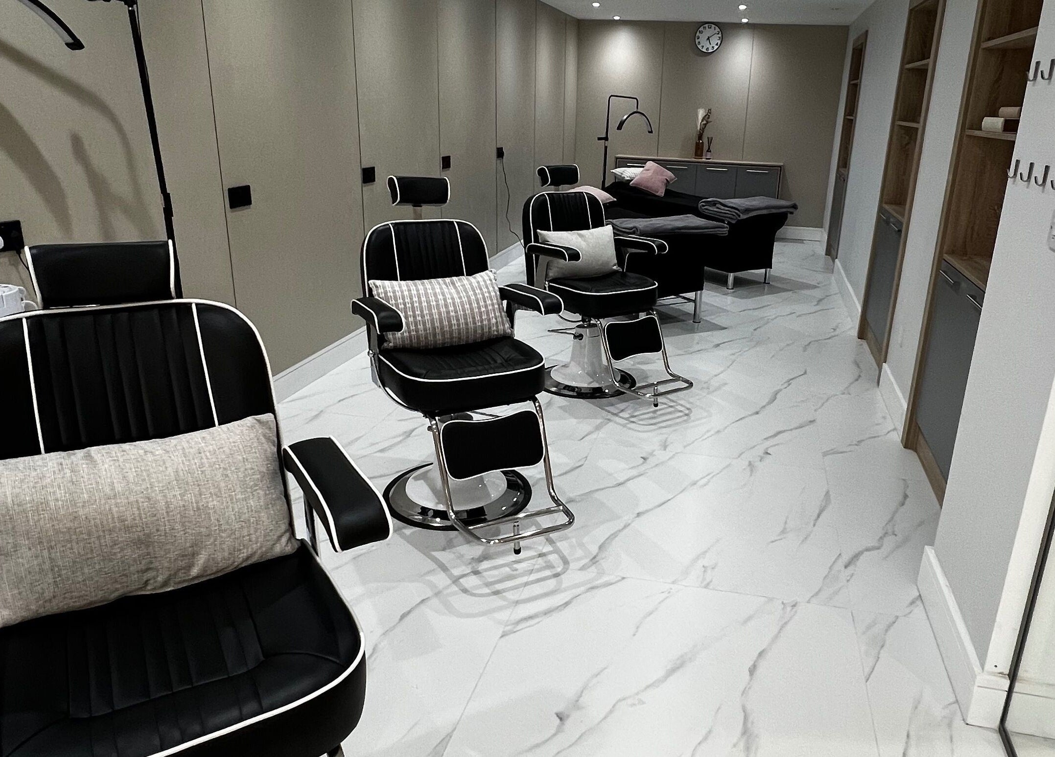 Modern black salon chairs at Nails Brows Stillorgan, Dublin, County Dublin, IE offer a sleek, comfortable setting.