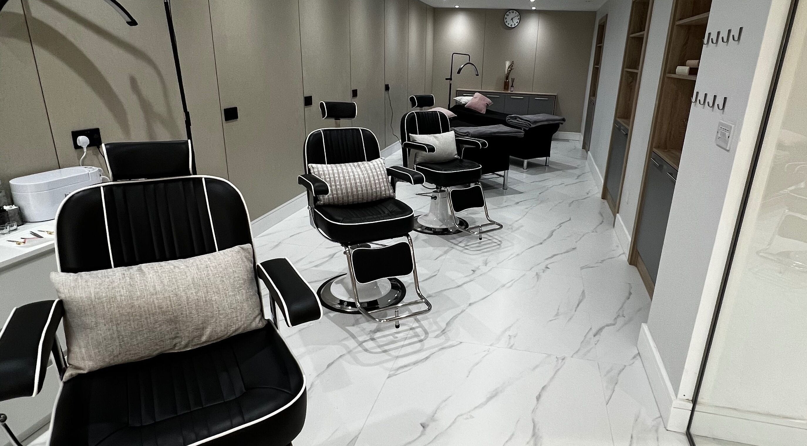 Modern black salon chairs at Nails Brows Stillorgan, Dublin, County Dublin, IE offer a sleek, comfortable setting.