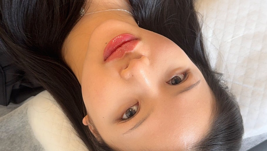 Woman with glossy lips at Browsol.ink, Melbourne, Victoria, AU, showcasing beauty treatment results.