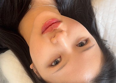Woman with glossy lips at Browsol.ink, Melbourne, Victoria, AU, showcasing beauty treatment results.