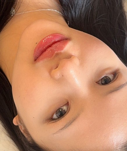 Woman with glossy lips at Browsol.ink, Melbourne, Victoria, AU, showcasing beauty treatment results.