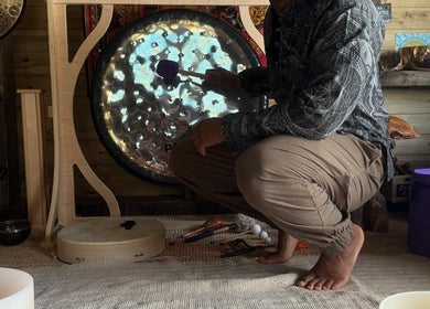Man playing gong at Mobile Massage & Relax in Runwell, England, GB, creating a tranquil wellness atmosphere.
