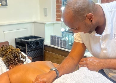 Massage therapist at Mobile Massage & Relax (The Zen Den), Runwell, England, gives relaxing back massage.