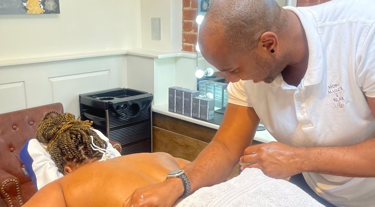 Massage therapist at Mobile Massage & Relax (The Zen Den), Runwell, England, gives relaxing back massage.