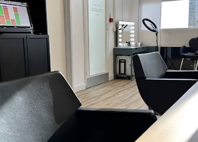 Elegant salon interior at Skyn Deep Beauty, Lossiemouth, Scotland, GB features stylish seating and modern decor.