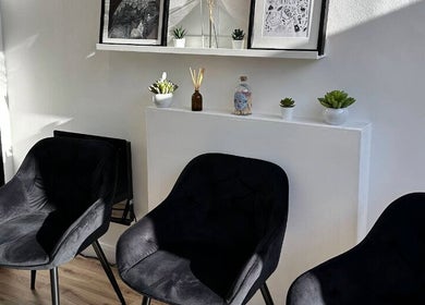 Chic waiting area at Skyn Deep Beauty, Lossiemouth, Scotland. Elegant chairs and decor create a serene environment.