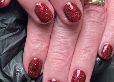 Red glitter nails manicure at Skyn Deep Beauty, Lossiemouth, Scotland, GB.
